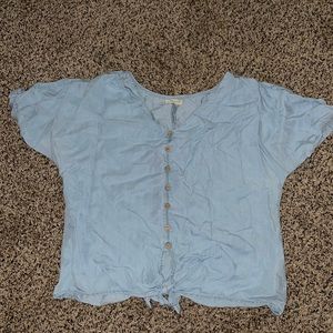 Blue blouse with brown bottoms and tie at bottom